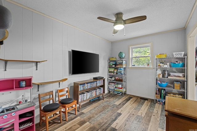 42 Desoto Cir, North Little Rock, AR 72116 - playroom featuring wood finished floors, a textured ceiling, ceiling fan, and ornamental molding