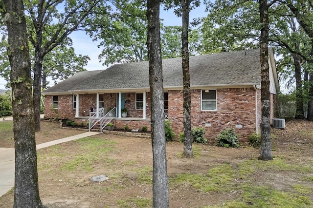 42 Desoto Cir, North Little Rock, AR 72116 - view of front of property featuring a porch, brick siding, a shingled roof, and central air condition unit