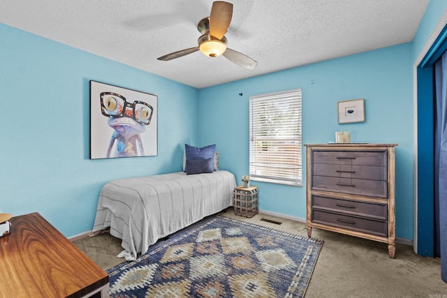 42 Desoto Cir, North Little Rock, AR 72116 - bedroom with carpet floors, baseboards, a textured ceiling, and a ceiling fan