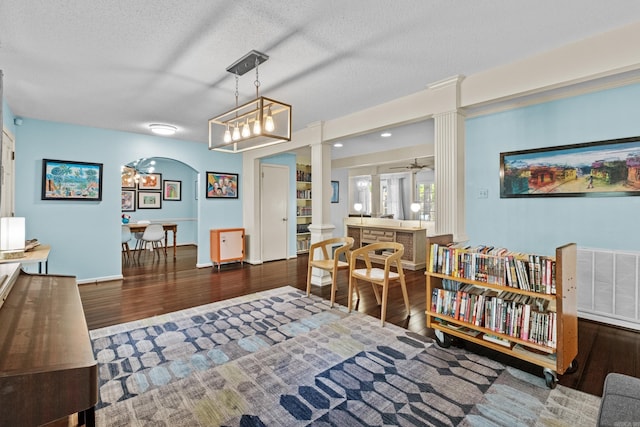 42 Desoto Cir, North Little Rock, AR 72116 - dining space with decorative columns, wood finished floors, ceiling fan, a textured ceiling, and a chandelier