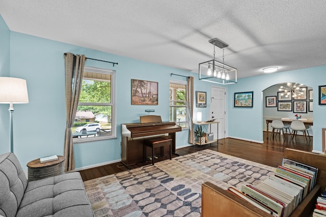 42 Desoto Cir, North Little Rock, AR 72116 - living room with a chandelier, wood finished floors, a textured ceiling, and baseboards