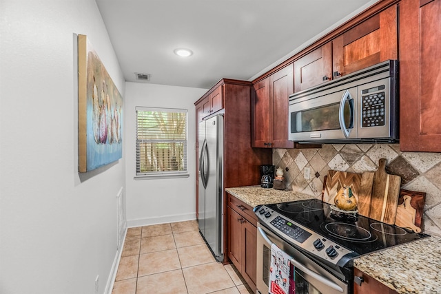 2510 Riverfront # 2, Little Rock, AR 72202 - kitchen featuring stainless steel appliances, backsplash, baseboards, light tile patterned flooring, and light stone countertops