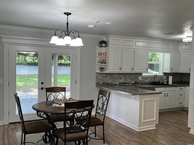 1906 Fernwood Cv, Benton, AR 72015 - kitchen featuring a sink, dark wood-style floors, dark countertops, white cabinetry, and ornamental molding