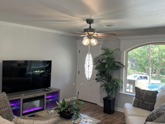 1906 Fernwood Cv, Benton, AR 72015 - living area featuring healthy amount of natural light, wood finished floors, a ceiling fan, crown molding, and baseboards
