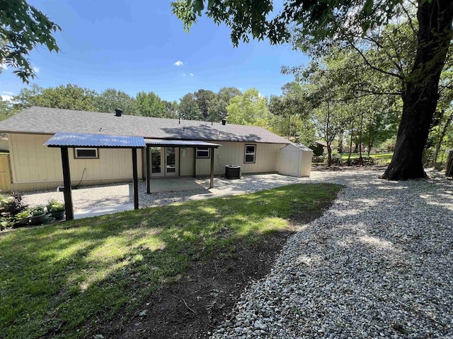1906 Fernwood Cv, Benton, AR 72015 - back of house featuring french doors, a patio, a shingled roof, and cooling unit