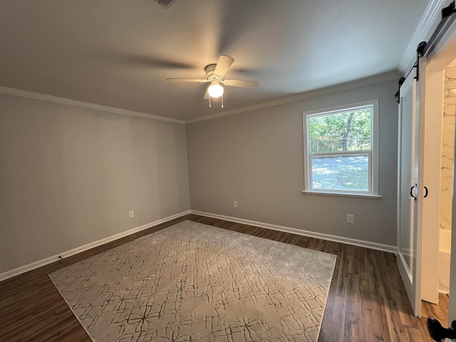 1906 Fernwood Cv, Benton, AR 72015 - unfurnished bedroom with baseboards, a barn door, dark wood finished floors, ornamental molding, and a ceiling fan