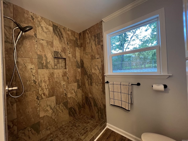 1906 Fernwood Cv, Benton, AR 72015 - bathroom with tiled shower, toilet, ornamental molding, baseboards, and wood finished floors