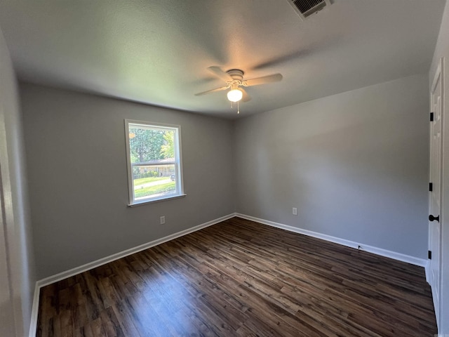 1906 Fernwood Cv, Benton, AR 72015 - empty room featuring a ceiling fan, dark wood-type flooring, and baseboards