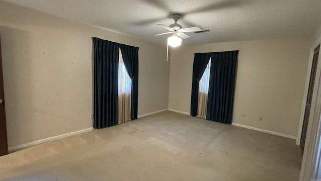 1410 Rock Creek Dr, Benton, AR 72019 - unfurnished room with light colored carpet, a ceiling fan, baseboards, and plenty of natural light