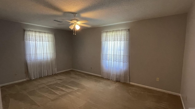 1410 Rock Creek Dr, Benton, AR 72019 - unfurnished room featuring healthy amount of natural light, a ceiling fan, carpet, baseboards, and a textured ceiling