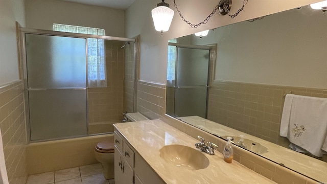 1410 Rock Creek Dr, Benton, AR 72019 - full bath with tile walls, toilet, vanity, tile patterned flooring, and bath / shower combo with glass door