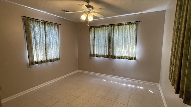 1410 Rock Creek Dr, Benton, AR 72019 - tiled empty room with baseboards, a textured ceiling, and a ceiling fan