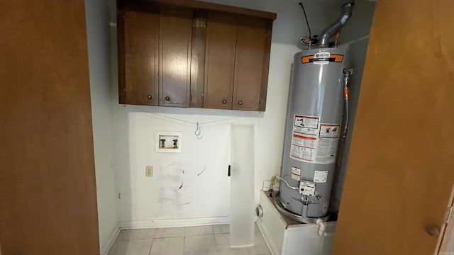 1410 Rock Creek Dr, Benton, AR 72019 - clothes washing area with cabinet space, water heater, light tile patterned floors, baseboards, and hookup for a washing machine