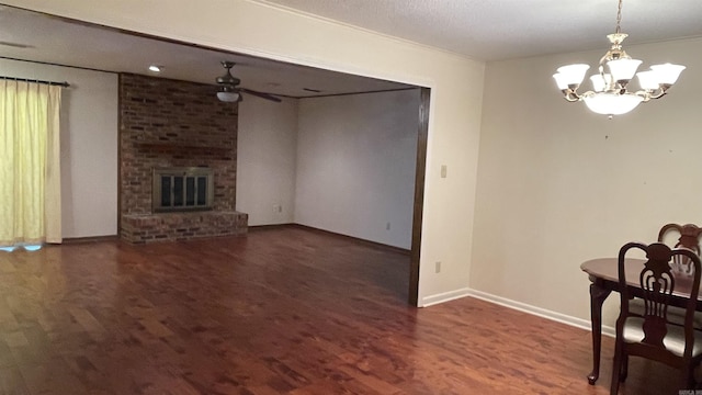 1410 Rock Creek Dr, Benton, AR 72019 - unfurnished living room with wood finished floors, ceiling fan, a chandelier, baseboards, and a brick fireplace