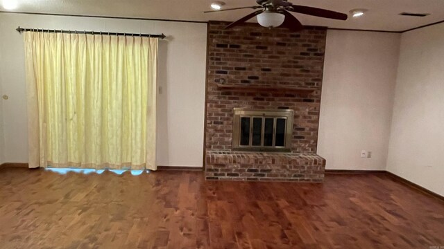 1410 Rock Creek Dr, Benton, AR 72019 - unfurnished living room with a ceiling fan, baseboards, wood finished floors, and a brick fireplace