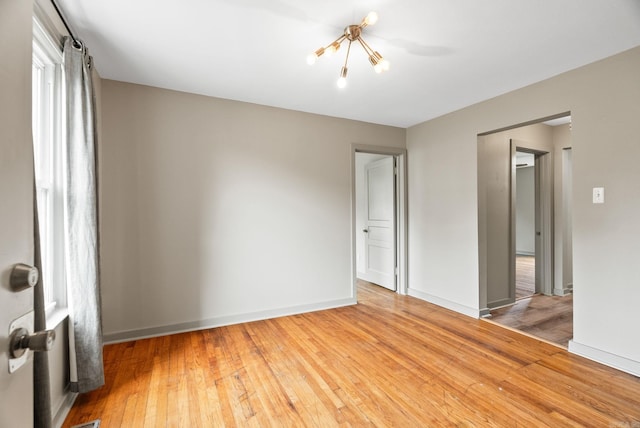 1724 W 19, Little Rock, AR 72202 - empty room with a chandelier, hardwood / wood-style flooring, and baseboards