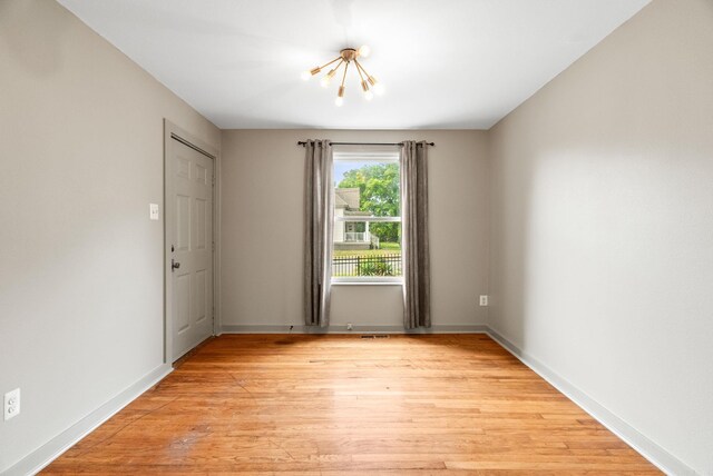 1724 W 19, Little Rock, AR 72202 - empty room with a chandelier, light wood-style flooring, and baseboards