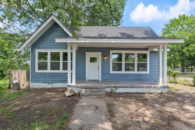 4300 W 16th St, Little Rock, AR 72204 - bungalow-style home with a porch, fence, and a shingled roof