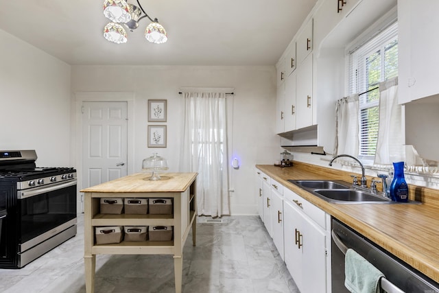 428 W S St, Benton, AR 72015 - kitchen with appliances with stainless steel finishes, a sink, light marble finish floors, white cabinets, and wooden counters
