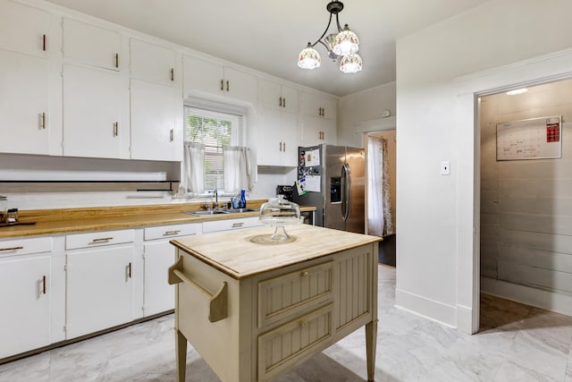 428 W S St, Benton, AR 72015 - kitchen featuring stainless steel fridge with ice dispenser, a sink, light marble finish flooring, and white cabinets