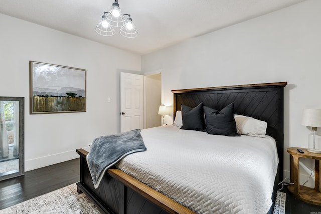 428 W S St, Benton, AR 72015 - bedroom with wood finished floors, baseboards, and a chandelier