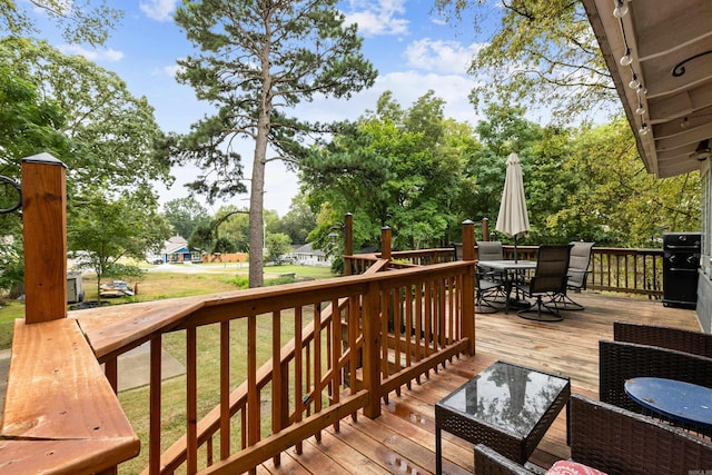428 W S St, Benton, AR 72015 - wooden terrace featuring outdoor dining area, a lawn, and view of wooded area