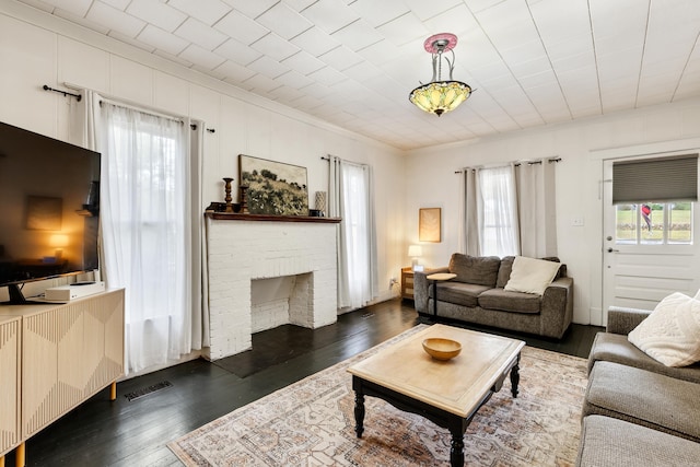 428 W S St, Benton, AR 72015 - living room featuring plenty of natural light, dark wood-style floors, crown molding, and a brick fireplace