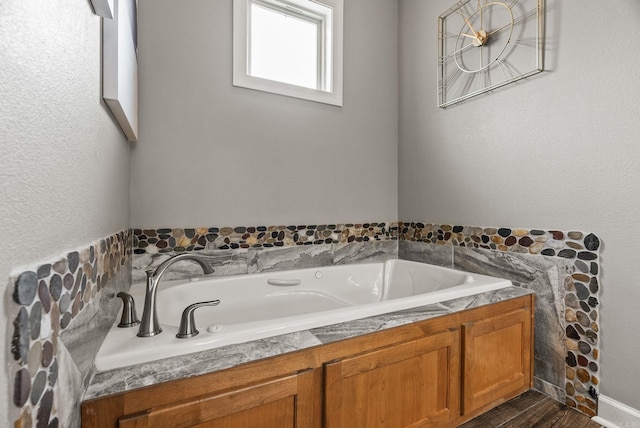 216 Lake Valley Dr, Maumelle, AR 72113 - bathroom with a bath and wood finished floors