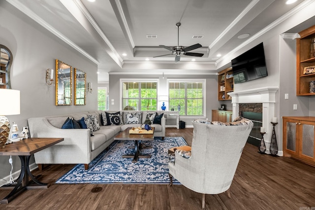 216 Lake Valley Dr, Maumelle, AR 72113 - living room featuring a tray ceiling, wood finished floors, a ceiling fan, a glass covered fireplace, and crown molding