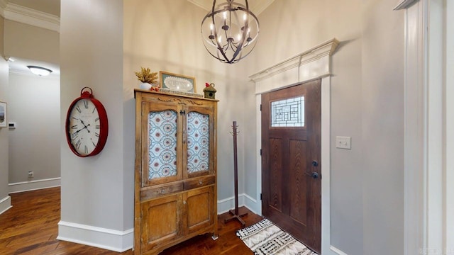 entrance foyer featuring a chandelier, baseboards, dark wood finished floors, and crown molding