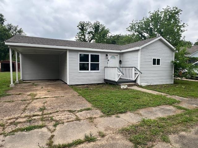 613 Paschal, Trumann, AR 72472 - view of front of house with concrete driveway, a front lawn, and an attached carport