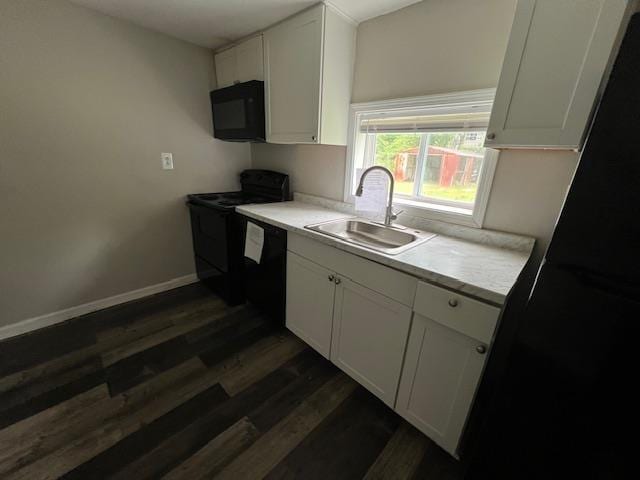 613 Paschal, Trumann, AR 72472 - kitchen with black appliances, a sink, dark wood-style floors, white cabinetry, and light countertops