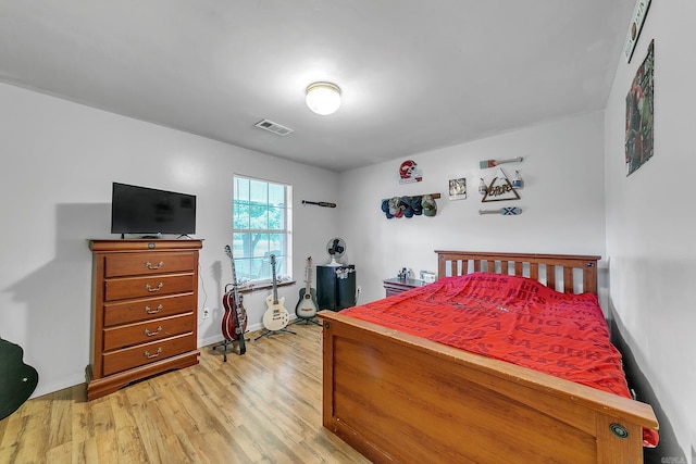 bedroom with light wood-style flooring and baseboards