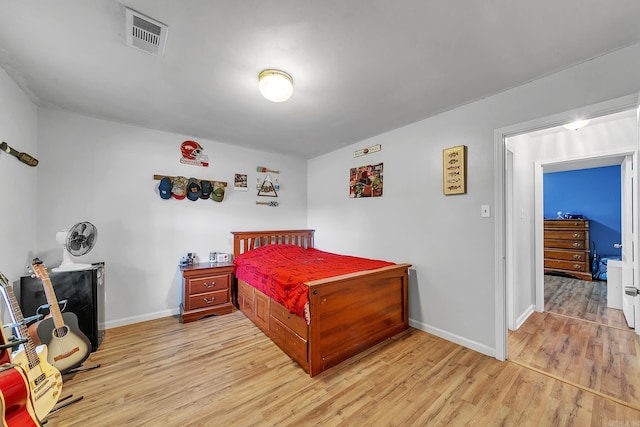 bedroom with light wood-style floors and baseboards