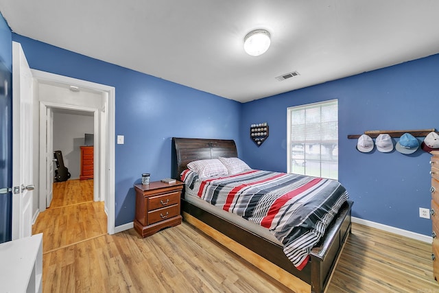 bedroom featuring wood finished floors and baseboards