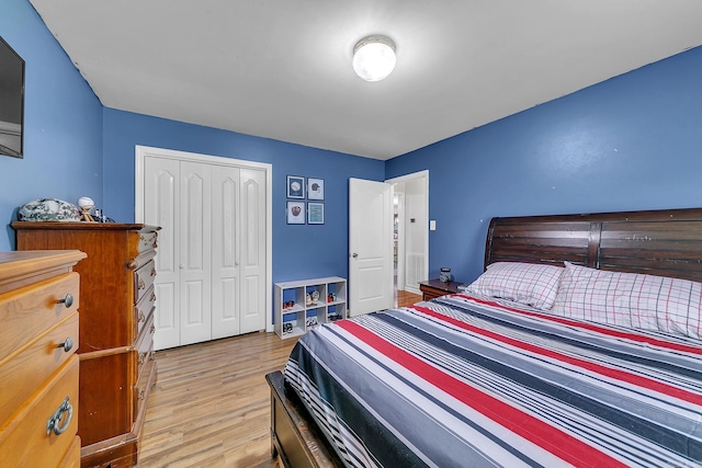 bedroom with a closet and light wood finished floors