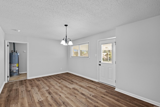 718 Coulter Rd, Sherwood, AR 72120 - unfurnished dining area with water heater, a textured ceiling, wood finished floors, a chandelier, and baseboards