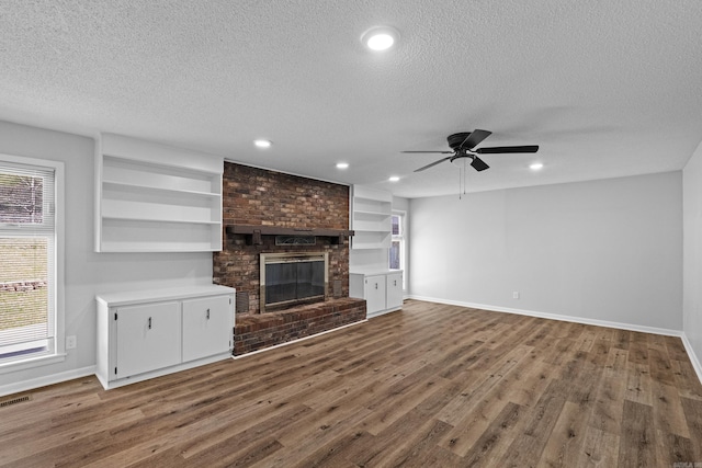 718 Coulter Rd, Sherwood, AR 72120 - unfurnished living room featuring a textured ceiling, baseboards, wood finished floors, a ceiling fan, and recessed lighting