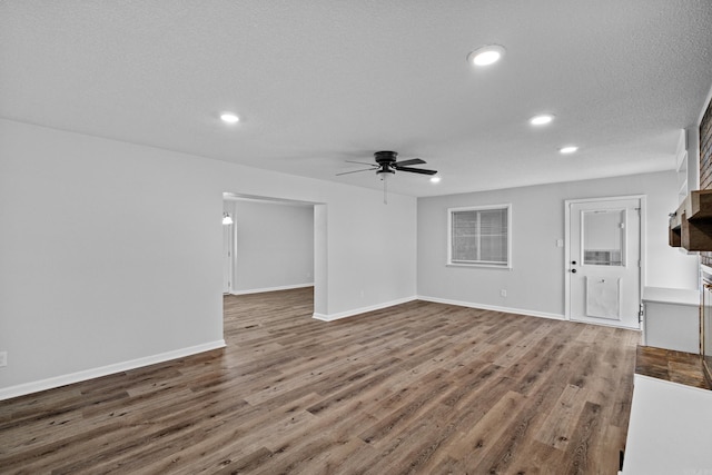 718 Coulter Rd, Sherwood, AR 72120 - unfurnished living room with a ceiling fan, recessed lighting, wood finished floors, and baseboards