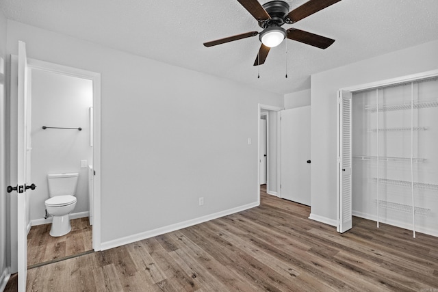 718 Coulter Rd, Sherwood, AR 72120 - unfurnished bedroom featuring wood finished floors, ensuite bath, baseboards, a closet, and ceiling fan