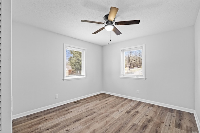 718 Coulter Rd, Sherwood, AR 72120 - empty room with wood finished floors, ceiling fan, baseboards, and a textured ceiling