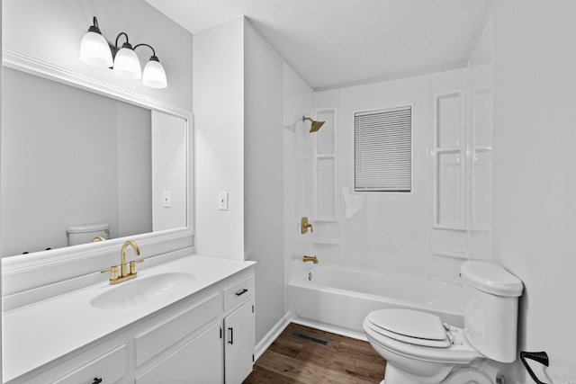 718 Coulter Rd, Sherwood, AR 72120 - bathroom with toilet, wood finished floors, vanity, a textured ceiling, and shower / washtub combination
