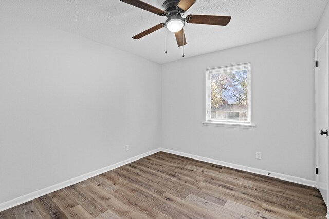 718 Coulter Rd, Sherwood, AR 72120 - spare room with wood finished floors, a ceiling fan, baseboards, and a textured ceiling