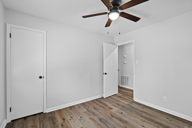 718 Coulter Rd, Sherwood, AR 72120 - unfurnished bedroom featuring wood finished floors, baseboards, and a ceiling fan