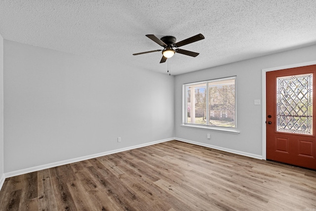 718 Coulter Rd, Sherwood, AR 72120 - foyer entrance featuring a textured ceiling, wood finished floors, ceiling fan, and baseboards