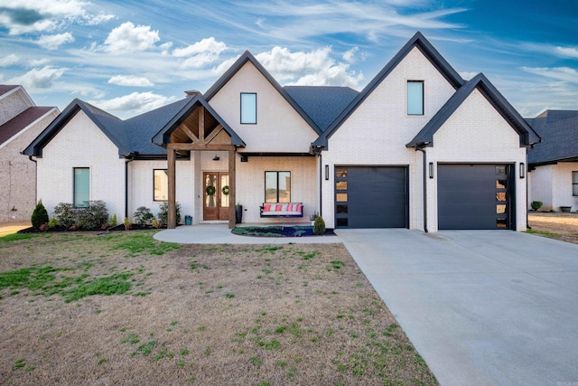 7021 Fields Dr, Alexander, AR 72019 - view of front of property with brick siding, a garage, driveway, and french doors
