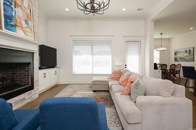 7021 Fields Dr, Alexander, AR 72019 - living area featuring a chandelier, wood finished floors, a fireplace, ornamental molding, and recessed lighting