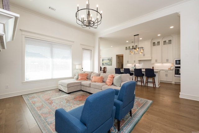 7021 Fields Dr, Alexander, AR 72019 - living area with a chandelier, wood finished floors, recessed lighting, crown molding, and baseboards