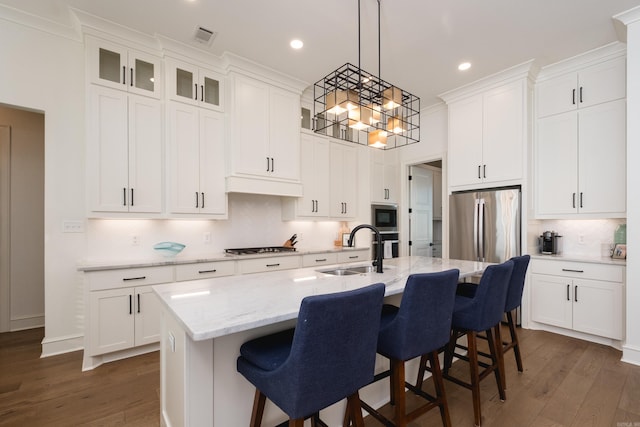 7021 Fields Dr, Alexander, AR 72019 - kitchen featuring a sink, dark wood finished floors, stainless steel appliances, a center island with sink, and backsplash