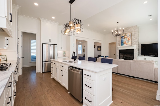 7021 Fields Dr, Alexander, AR 72019 - kitchen featuring stainless steel appliances, a sink, a chandelier, crown molding, and wood finished floors